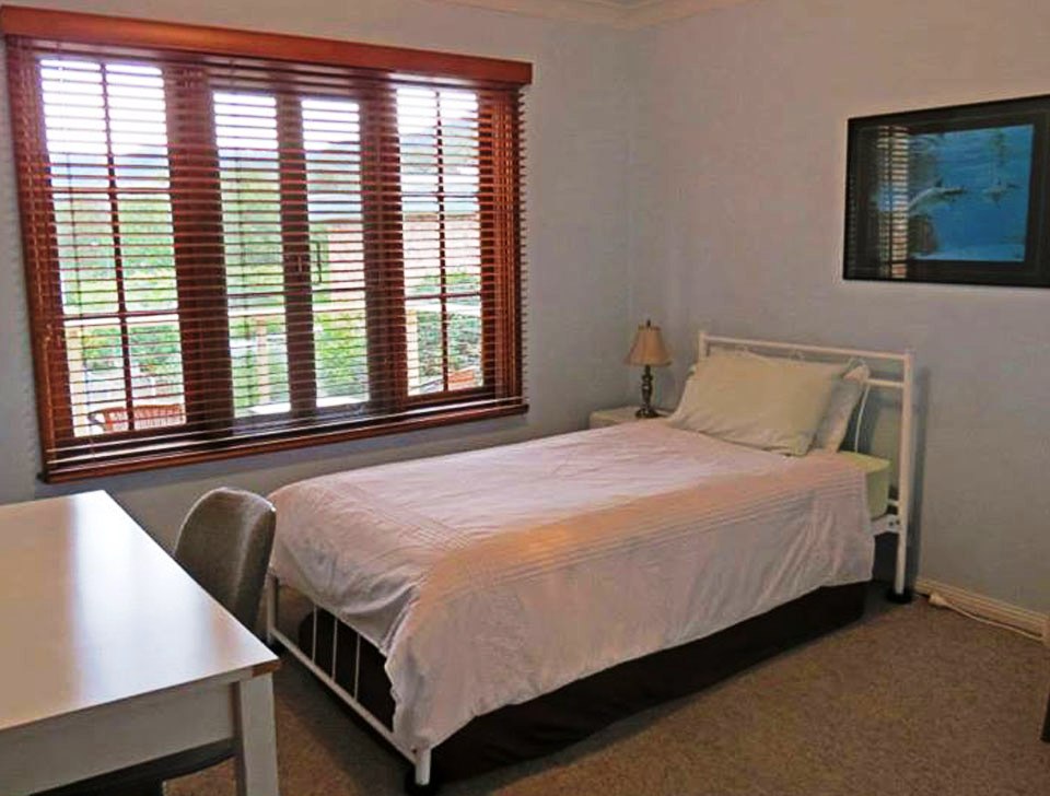 Bedroom interior with queen bed and natural light